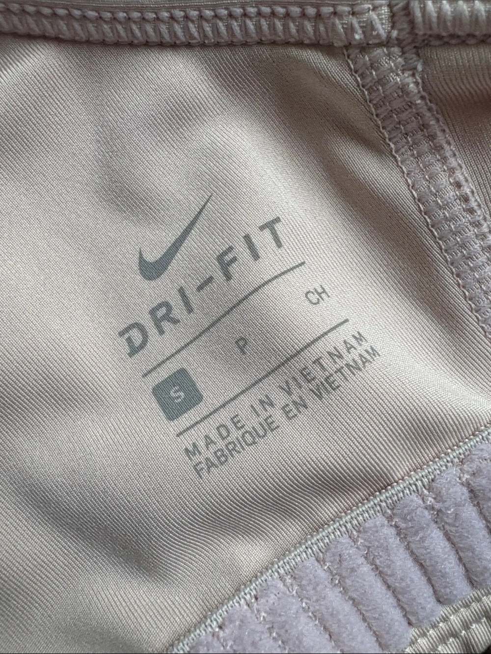 Nike Women’s light beige Racerback Sports Bra with Black Swoosh